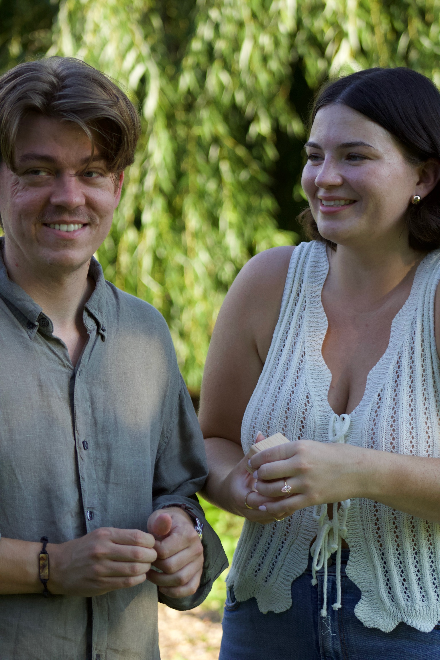 Morgan and Jesse holding hands walking through the garden