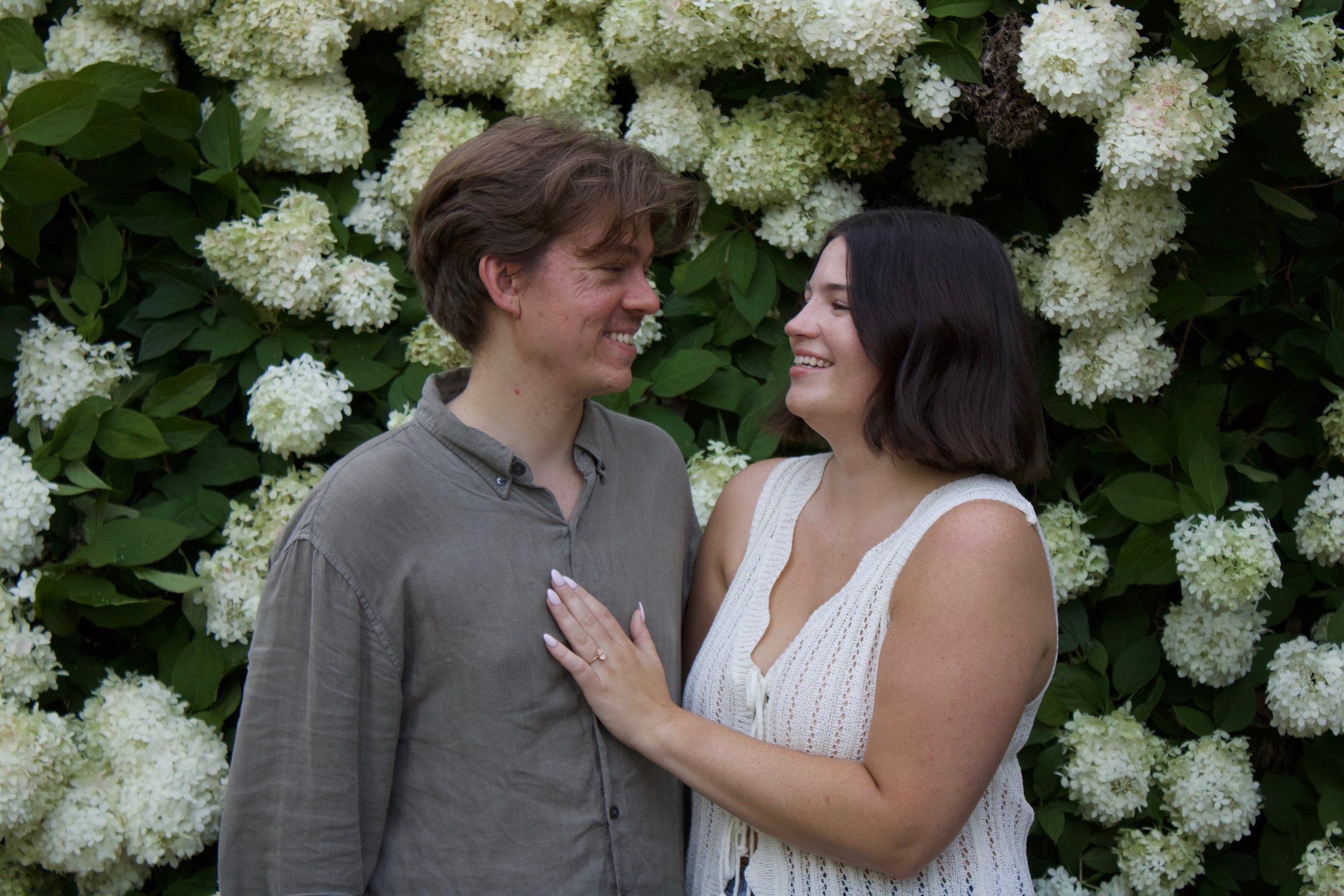 Morgan and Jesse sharing a laugh surrounded by trees